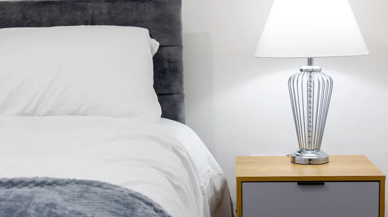 The Merry Hill Lounge bedroom with a double bed and table lamp
